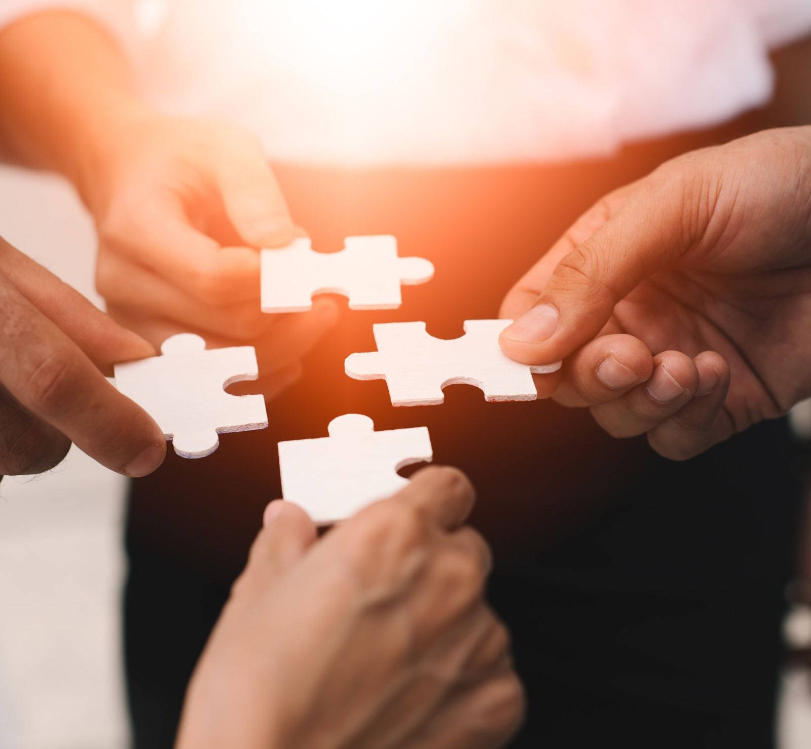 Team members fitting puzzle pieces together